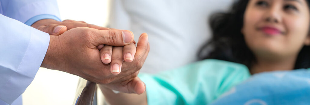 person holding patient's hand